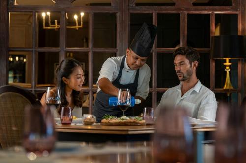 a chef preparing a meal in a restaurant at Marriott Vacation Club, Khao Lak Beach Resort in Khao Lak