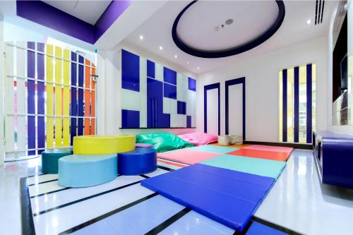 a living room with colorful chairs and a couch at Marriott Vacation Club, Khao Lak Beach Resort in Khao Lak