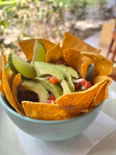 a bowl of food with tortilla chips on a table at Hotel Bahia Esmeralda in Potrero