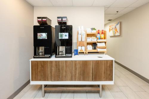 a counter in a room with a coffee machine at Holiday Inn Express Hotel & Suites Charleston-Ashley Phosphate by IHG in Charleston