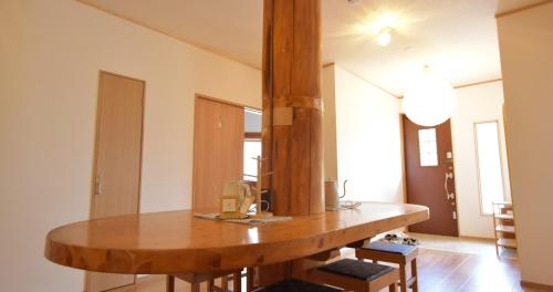 a kitchen with a wooden table in a room at toit vert in Tanabe