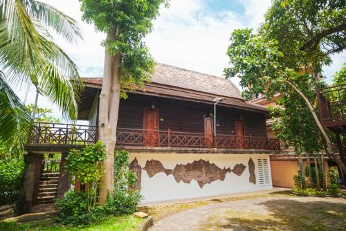 a house with a fence in front of it at Yellow Sun Kep in Kep