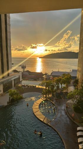 a resort with a pool and a water park at The Shore Kota Kinabalu by Ems Executive Suites Seaview in Kota Kinabalu