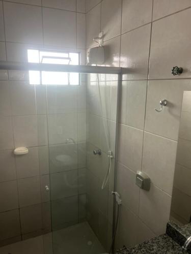 a shower with a glass door in a bathroom at Casa Progresso de Anápolis in Anápolis