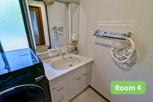 a bathroom with a sink and a washing machine at Vacation House 1 in Funabashi
