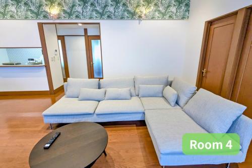 a living room with a couch and a table at Vacation House 1 in Funabashi