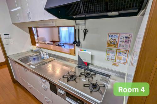 a kitchen with a stove and a counter top at Vacation House 1 in Funabashi