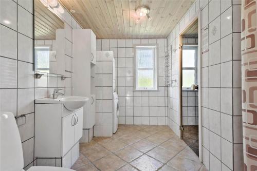a white bathroom with a sink and a toilet at C11307-Tarm-Rorsangervaenget-1 in Tarm
