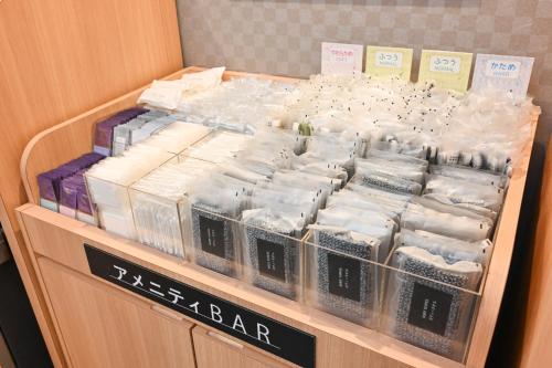 a display case with a bunch of diapers in plastic containers at Sanco Inn Kyoto Hachijoguchi Shikinoyu in Kyoto