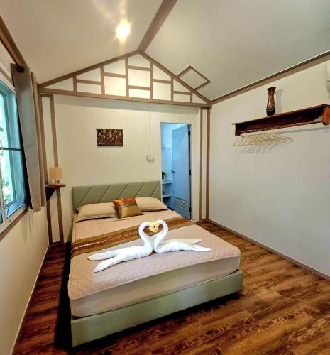 a bedroom with two beds with swans made out of towels at Jungle View Resort in Ko Chang