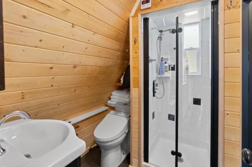 a bathroom with a toilet and a shower at A-Frame At Entrance to Rainier- Hot Tub & WiFi in Ashford