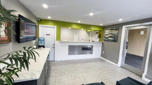 a living room with green walls and a fireplace at The SeaScape Inn in San Francisco