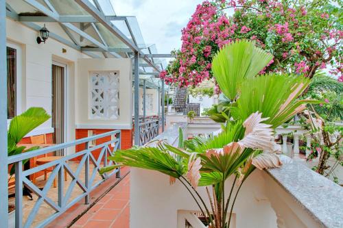 a balcony of a house with pink flowers at S79 Blue in Phu Quoc