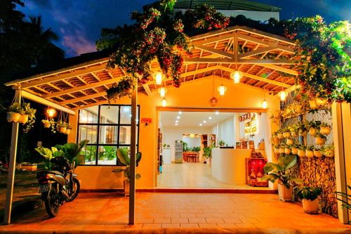 a store front with a building with plants on it at S79 Blue in Phu Quoc