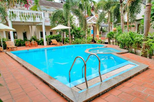 a swimming pool in a courtyard with a resort at S79 Blue in Phu Quoc