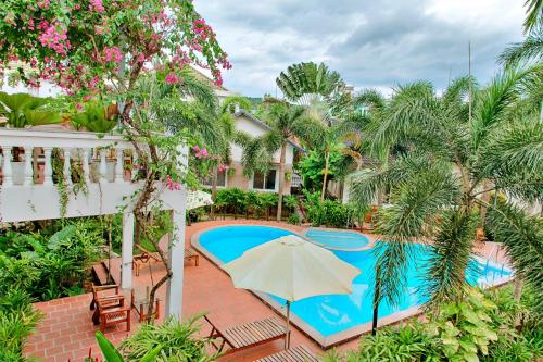 a resort with a swimming pool and an umbrella at S79 Blue in Phu Quoc