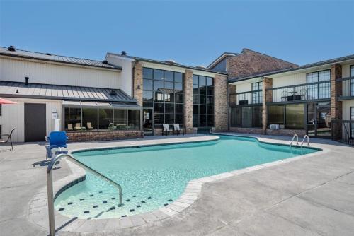 a swimming pool in front of a building at SureStay Plus Hotel by Best Western Greenwood in Greenwood