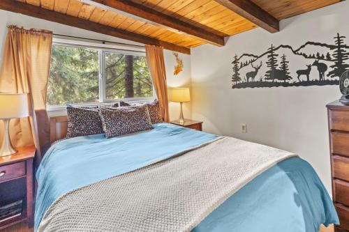 a bedroom with a bed and a window at Rainier Vintage Retreat With Hot Tub-Fireplace-WiFi in Ashford