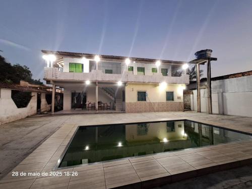 a house with a swimming pool in front of it at Casa Ariramba - Your place in COP30 in Belém