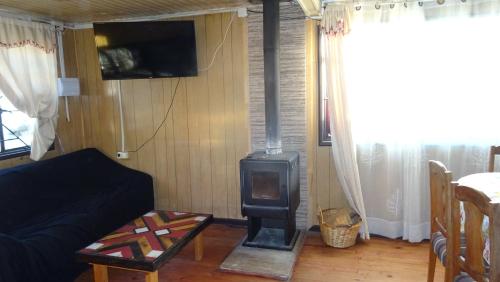 a living room with a wood stove in it at casa completa Balmaceda 77 in Concepción