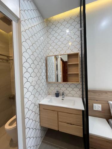a bathroom with a sink and a mirror at Villa ATH Novaworld Phan Thiết 3PN in Bình Tú