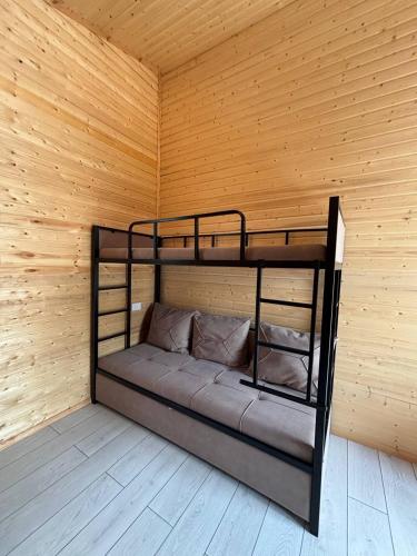 a room with two bunk beds in a wooden wall at Jargylchak-Sunrise in Kichi-Jargylchak