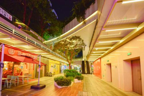 a building with tables and chairs on a sidewalk at Dabaizhijia Executive Apartment Bantian Huawei Branch in Shenzhen