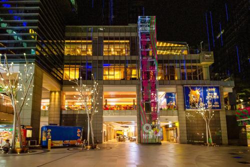 a large building with lights in front of it at night at Dabaizhijia Executive Apartment Bantian Huawei Branch in Shenzhen