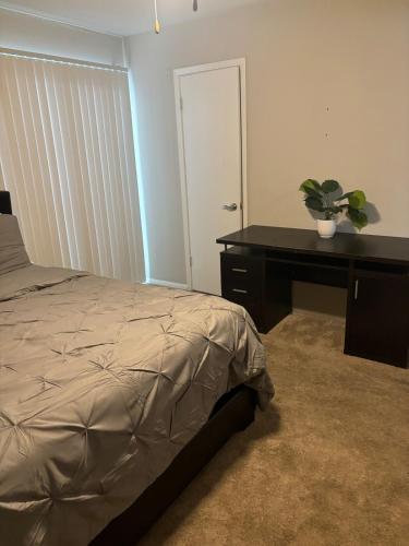 a bedroom with a bed and a desk with a potted plant at Quaint one bedroom flat in Atlanta