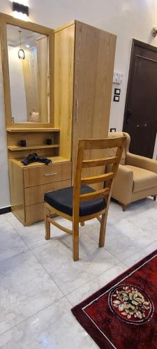 a room with a chair and a cabinet and a mirror at Luxor Sapphire in Luxor