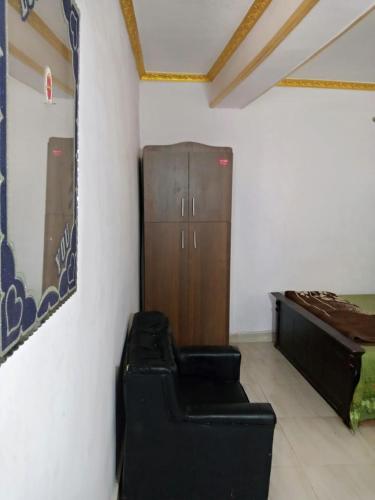 a room with a bed and a cabinet in a room at Giza Pyramids Hotel in Cairo
