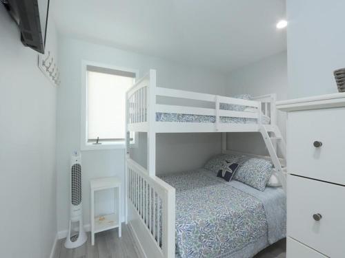 a white bunk bed in a white room at Ocean Front Condo Beach Haven, Pool Beach Badges Wifi Ocean Views in Beach Haven