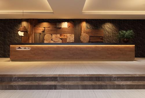 a lobby with a bench with shoes on it at Healing Mind International Hotel Guangzhou Tianhe Sports Center Linhexi Metro Station Branch - Free Deliver Service to Guangzhou Baiyun International Airport & Free Deliver Service to Canton Fair Complex During Canton Fair Period in Guangzhou