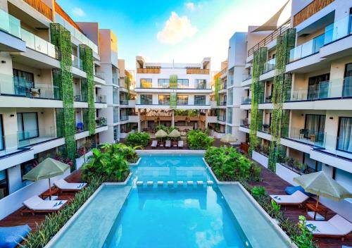 an image of an apartment building with a swimming pool at Studio with balcony in the downtown, WiFi 150MB, laundry and parking free in Tulum