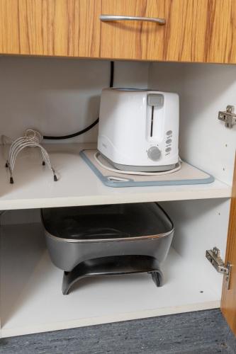 a kitchen appliance sitting on a shelf in a drawer at Grove Park Motor Lodge in Blenheim
