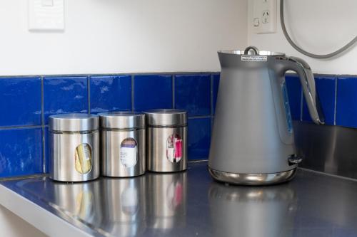 a row of canisters on a counter in a kitchen at Grove Park Motor Lodge in Blenheim