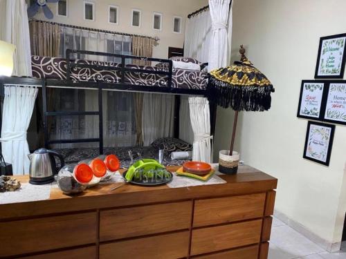 a wooden dresser with food on top of it at Coliving Jogja SWEET HOME Kost Lengkap di Jogjakarta in Yogyakarta
