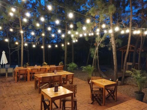 a patio with wooden tables and string lights at Roca Venados in Mascota