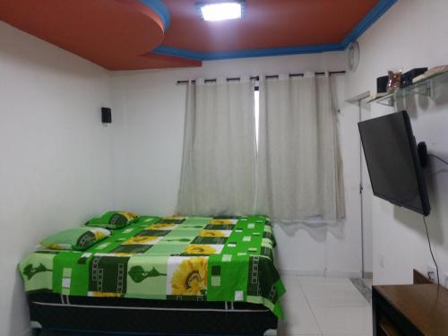 a bedroom with a bed and a flat screen tv at Residencial Adam Lima in Belém