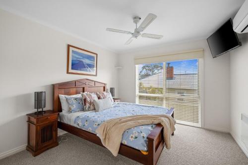 a bedroom with a bed and a window at Rhyll Seaside Penthouse in Rhyll
