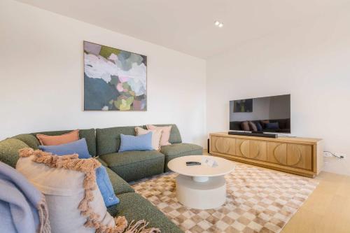 a living room with a couch and a table at Stylish Spacious Apartment in Malvern in Melbourne
