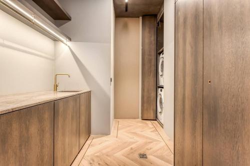 a laundry room with a sink and a washing machine at Glamorous Stylish Getaway in Garðakauptún