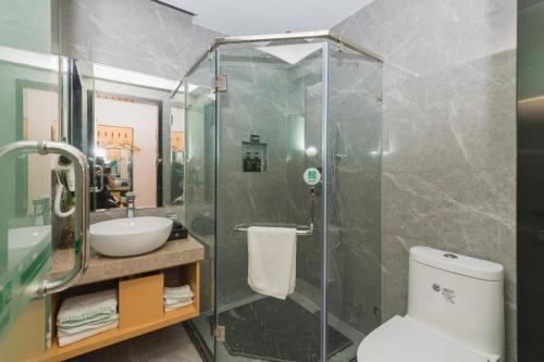 a bathroom with a shower and a toilet and a sink at Green Tree Inn Express Fuzhou Three Lanes and Seven Alleys Nanmendou Metro Station in Fuzhou