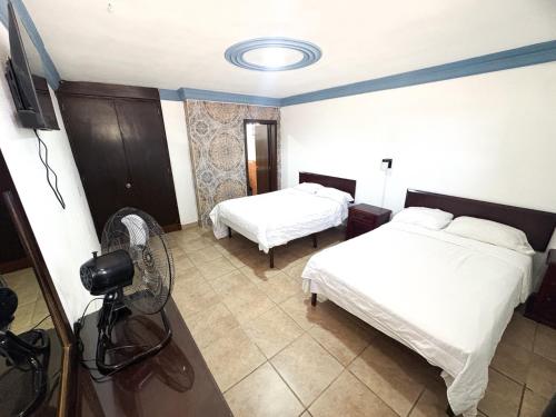 a hotel room with two beds and a camera at Hotel paseo de la montaña in Silao