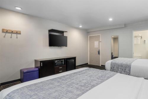 a hotel room with two beds and a flat screen tv at SureStay Hotel by Best Western Beverly Hills West LA in Los Angeles
