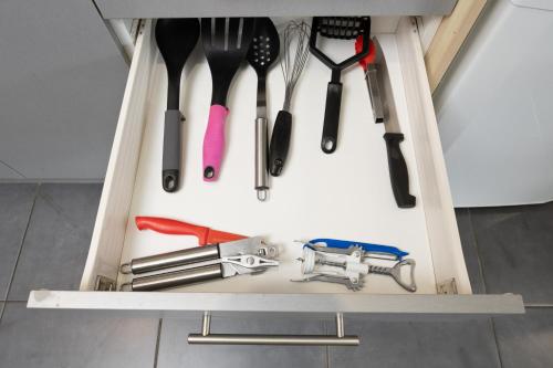 a drawer filled with lots of kitchen utensils at Grove Park Motor Lodge in Blenheim