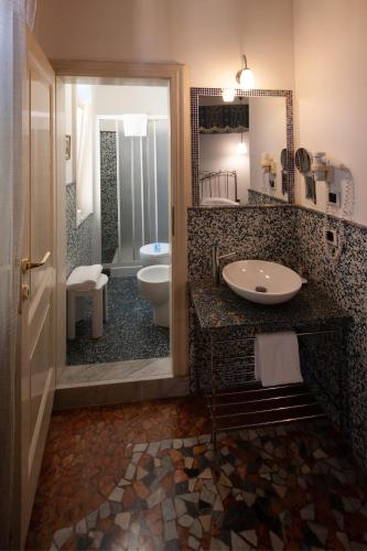 a bathroom with a sink and a toilet at CityHotel Cristina Vicenza in Vicenza