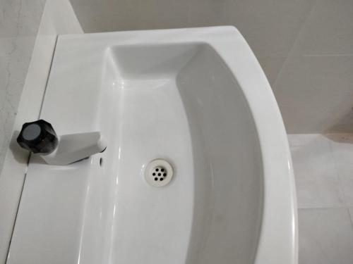a white bath tub with a toilet in a bathroom at Gnaanams Hotel and Restaurant in Jaffna