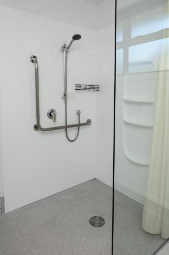 a shower in a bathroom with a glass door at Grove Park Motor Lodge in Blenheim