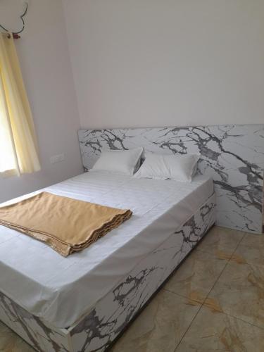 a bed with a blanket on it in a bedroom at Srivaari Residency Villa in Pondicherry